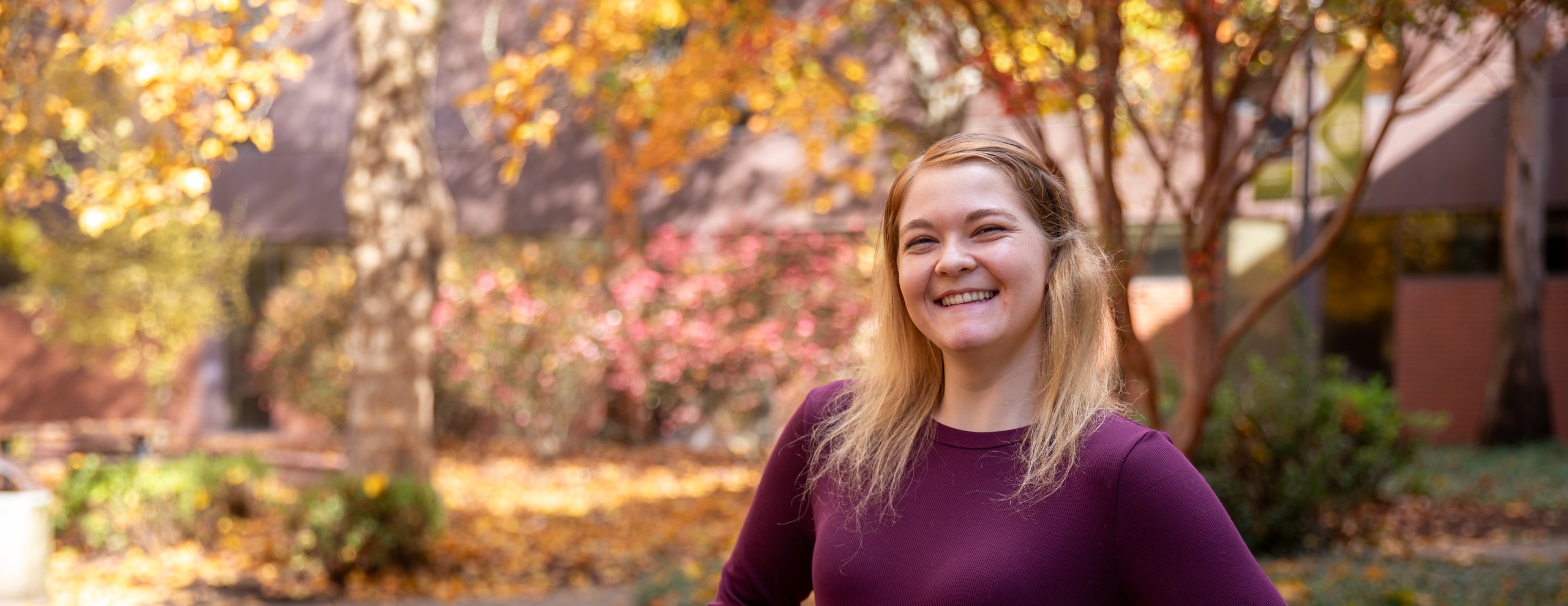 Maddie smiling at the Salem Campus during fall